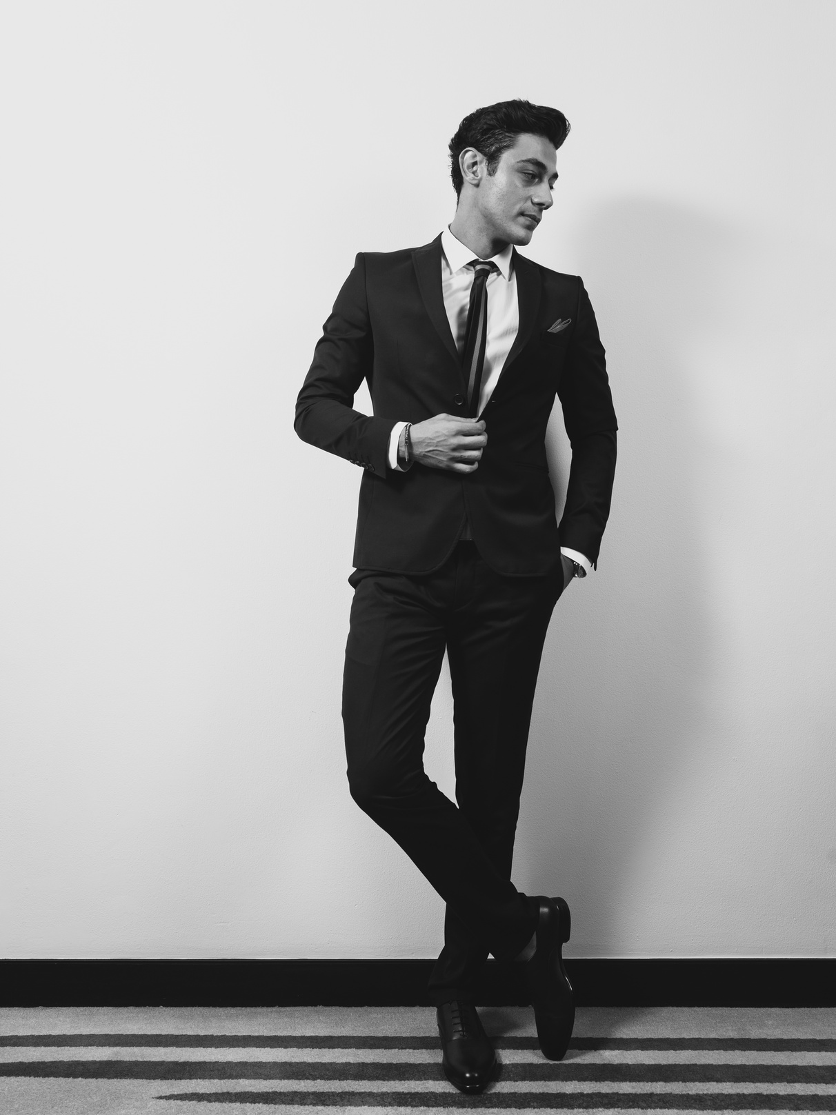 Man Wearing Suit Jacket, Dress Shirt, and Dress Pants Standing Near Wall